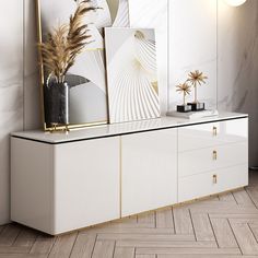 a white and gold sideboard with art on it