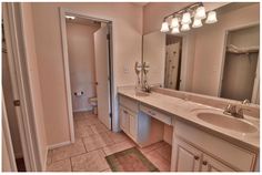 a bathroom with two sinks and a large mirror