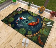 two koi fish swimming in a pond with lily pads and water lilies on the floor