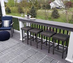 three stools are sitting on the back porch