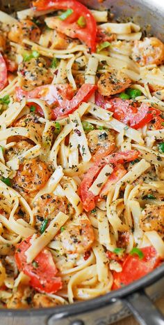 a skillet filled with pasta and vegetables