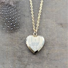 "This vintage locket is engraved with a double heart design on the front; the reverse is plain. The 12k gold filled heart opens revealing two frames in which to place your favorite photos. The locket hangs from a new 14k gold filled cable chain finished tiny gold balls at the lobster clasp closure. Locket 24x20mm Necklace length 18\" (45cm) ✦All of our vintage lockets ship with complimentary insurance✦ ✤Our entire selection of lockets can be found here✤ http://www.etsy.com/shop/LexiandGem?sectio Brass Heart Pendant Wedding Jewelry, Brass Heart Pendant Jewelry For Wedding, Heart-shaped Brass Jewelry For Wedding, Heart-shaped Brass Wedding Jewelry, Gold Jewelry With Engraving Option For Wedding, Traditional Heart-shaped Jewelry For Weddings, Traditional Heart Jewelry For Wedding, Traditional Heart-shaped Wedding Jewelry, Double Heart Charm Locket Necklace For Wedding