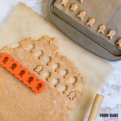 some cookies are laying on top of a cookie sheet and next to a baking pan