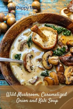 a wooden bowl filled with mushroom, caramelized onion and kale soup on top of a blue table