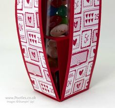 a red and white box filled with lots of candy