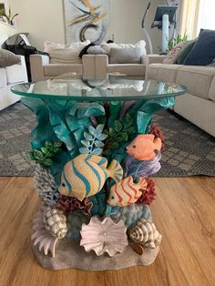 a glass table topped with lots of sea life on top of a hard wood floor