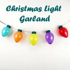 christmas light garland with colorful balloons hanging from it's string and the words, christmas light garland