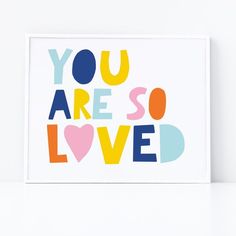 a card with the words you are so loved written in multicolored letters on it