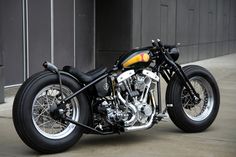 a black and yellow motorcycle parked in front of a building