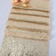 the table runner has flowers on it and sequins