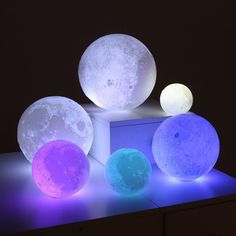 three moon lamps sitting on top of a table