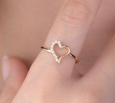 Our open heart ring is 14k solid gold. Its half of the heart is decorated with charming zircon stones. Our gold ring has a dainty style that can fit your all outfit. Our hollow heart ring makes happy your loved ones. It will be a perfect gift for valentine's day, mother's day, graduations, anniversaries, or birthdays. 🎁 If you want, you can add a gift note for your loved ones. It arrives in a special jewelry gift box. ✨ We respond to your questions happily. Your question will be answered within Valentine Gold Jewelry, Dainty Heart-shaped Diamond Ring For Valentine's Day, Dainty Open Heart Ring For Anniversary, Valentine's Day Dainty Heart Ring With Diamond Accents, Dainty Open Heart Wedding Ring, Valentine's Day Diamond Heart Open Ring, Yellow Gold Open Heart Wedding Ring, Valentine's Day Heart-shaped Dainty Diamond Ring, Valentine's Day Heart Shaped Diamond Ring