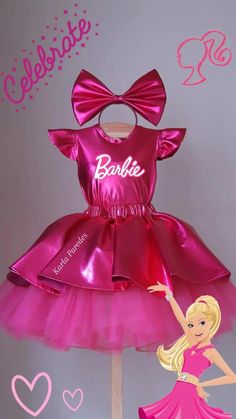 a barbie doll is standing next to a pink dress on a stick with the word barbie written on it