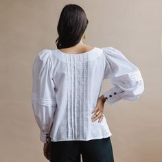 Extraordinary pintuck details on both the romantic puffed sleeves and the front and back of this blouse create a gorgeous statement piece. Billowy soft handwoven cotton and artisan-handicraft make for a piece that looks good and feels good. Sizing: This shirt runs large. We recommend ordering a size down. XS (US size 2-4) S (US size 6-8) M (US size 10-12) L (US size 14-16) Materials and Care: Handwoven cotton. We recommend dry-cleaning these garments or machine-wash cold with like colors. Hang t Balloon Sleeve Blouse, Puffed Sleeves, Pin Tucks, Statement Pieces, Puff Sleeve, Sleeve Blouse, Tunic Tops, That Look, Hand Weaving