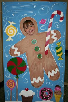 a painting of a child's gingerbread man with candy canes and candies