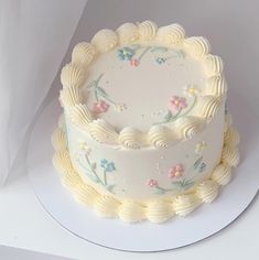 there is a white cake with flowers on it