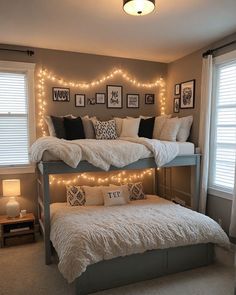 two bunk beds with lights above them in a bedroom decorated for christmas or new year's eve