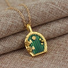 Gold Hobbit Hole, Lord Of The Rings Pendant Locket Necklace - Green Door Green Charms Jewelry Perfect For Gifts, Green Metal Pendant Charm Necklaces, Green Metal Clavicle Chain Jewelry, Green Alloy Jewelry For Gift, Green Locket Jewelry For Gift, Green Round Pendant Metal Jewelry, Green Jewelry With Adjustable Chain For Anniversary, Green Locket Jewelry For Wedding, Green Adjustable Chain Jewelry For Anniversary