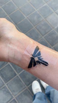 a person's arm with a tattoo on it that has an arrow in the middle