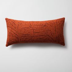 an orange pillow with black lines on it