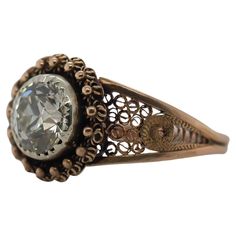 an antique ring with a large stone in the center and filigrees around it