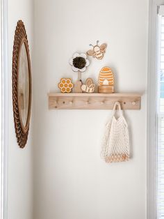 a wooden shelf with various items on it next to a mirror and window sill