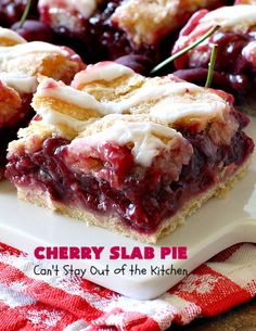 cherry slab pie with icing on a white plate