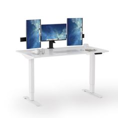 two computer monitors sitting on top of a white desk