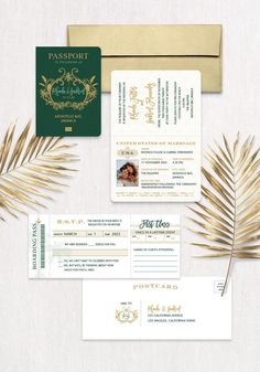 the wedding stationery is set up on top of a table with palm leaves and gold foil