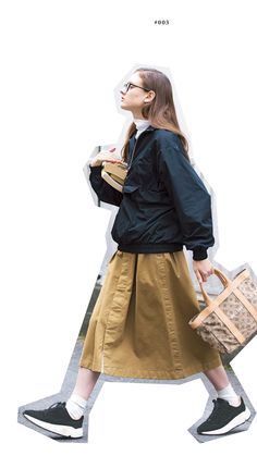 a woman walking down the street in a skirt and jacket with her handbag on her hip