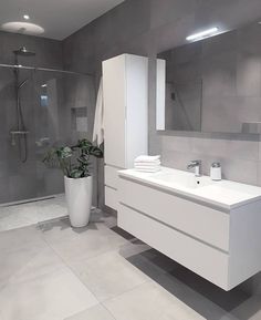 a modern bathroom with grey walls and white fixtures