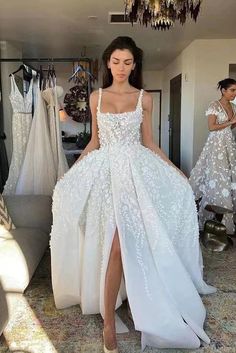 a woman in a white wedding dress posing for the camera