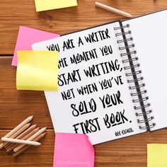 a notebook with sticky notes and pencils next to it on a wooden table that says, you are a writer the moment you start writing not when you've