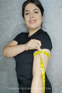 a woman with a measuring tape wrapped around her arm