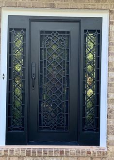 a black front door with decorative glass panels