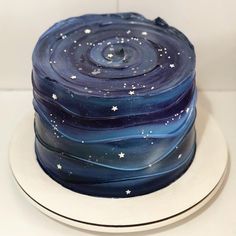 there is a blue cake with stars on the icing and it looks like something out of space