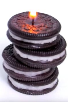 a stack of cookies sitting on top of each other with a lit candle in the middle