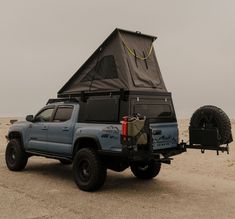 a truck with a tent attached to it's back