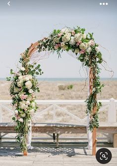 an outdoor ceremony setup with flowers and greenery