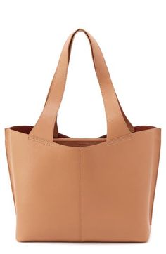 Richly textured leather adds timeless sophistication to a spacious tote designed with a divided interior perfect for organizing your daily essentials. Structured silhouette with flat base and protective feet Lined Leather Imported Natural Leather Hobo Tote Bag, Classic Smooth Grain Hobo Tote Bag, Everyday Textured Leather Hobo Tote Bag, Beige Textured Leather Hobo Tote Bag, Brown Textured Leather Hobo Tote Bag, Coconut Shell, Daily Essentials, Womens Tote Bags, Leather Tote