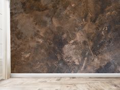 an empty room with a brown wall and wooden floor