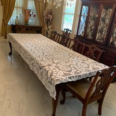 a dining room table covered with a white lace