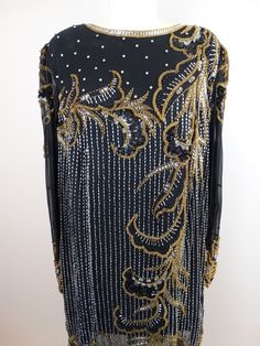 "This is an amazing vintage piece! It's fully embellished with gold and silver beading, sequins and crystal rhinestones in an avant garde art deco design. SO STUNNING! It's in excellent condition! Measurements: Bust - 46\" Waist - 46\" Hips - 46\" Shoulders - 16\" Sleeves - 24\" Length - 33\" Tag Size - 14 This item comes from a pet-free and smoke-free home. If you would like more info or have any questions, please don't hesitate to ask!" Vintage Embellished Long Sleeve Dresses, Traditional Gold Evening Dress, Elegant Costume Dress With Sequins, Vintage Embellished Dresses For Festive Occasion, Gold Embellished Festive Dress, Festive Embellished Gold Dress, Gold Embellished Dress For Festive Occasions, Festive Gold Embellished Dress, Vintage Gold Dress For Festive Occasion