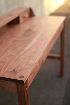 a wooden table sitting on top of a carpeted floor