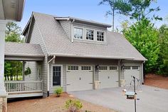 a two car garage is shown in front of a house