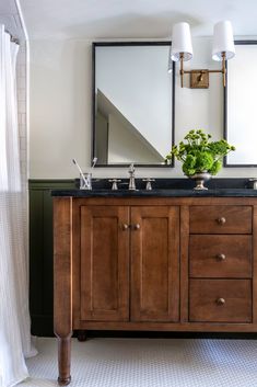 a bathroom with two sinks and a large mirror