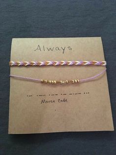 two bracelets on top of a piece of paper with the words always written on it