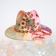 Pink rhinestones surround a fanciful French poodle broach and wrap the band of this marble print faux felt fedora. Perfect for festivals and fancy dress parties, or if you're like me, anytime and anywhere because you simply love a little bling. Condition: new Headband size: 23 -24 in. Self-adjustable using the easy adhesive padded band inserts included for you to fit the hat perfectly to your head. Crown height: 5 in Brim width: 3 in Cotton/poly fabric. Spot clean only. TERMS: All sales final. No exchanges or refunds. SHIPPING: Price includes shipping and handling. Your hat will be lovingly packaged to prevent damage. Orders ship in 1-2 business days via USPS. US domestic shipping only. Pink Fedora For Festivals, Fun Pink Fedora Hat, Pink Fedora For Western-themed Events, Customizable Pink Hat With Curved Brim, Luxury Pink Fedora With Curved Brim, French Poodle, Head Crown, Headband Size, Zsa Zsa