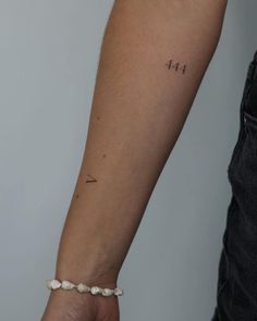 a person's arm with a small tattoo on the left side of their arm