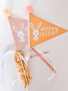 there are two bunting flags on the wall with bunny ears attached to each one